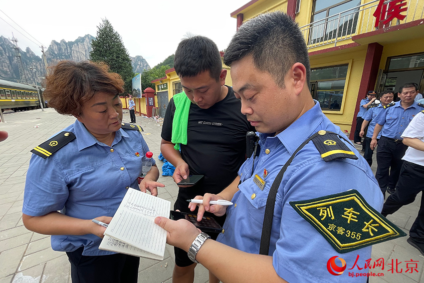 列車員和屬地工作人員在站臺再次確認有無遺漏群眾。人民網記者 尹星云攝